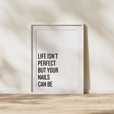 a white framed poster with the words life isn't perfect but your nails can be