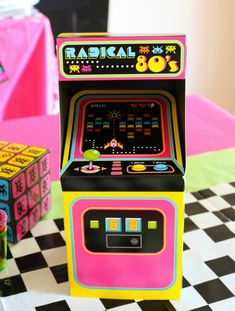 an arcade machine sitting on top of a checkered table