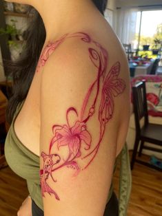 a woman with a tattoo on her arm has a pink flower and butterfly in it