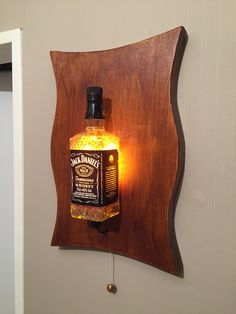 a bottle of jack daniels whiskey is mounted to a wall