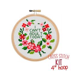 the cross stitch kit is ready to be made into an embroidered hoop with flowers on it