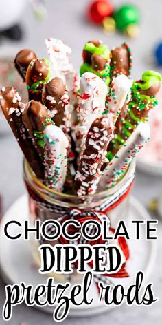 chocolate dipped pretzel rods in a glass jar with candy canes and sprinkles