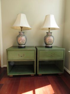 two lamps sitting on top of green nightstands