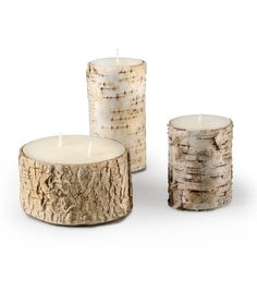 three wooden candles sitting next to each other