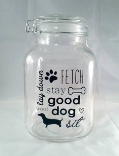 a glass jar with a dog saying on it