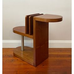 three wooden tables sitting on top of a hard wood floor next to a white wall