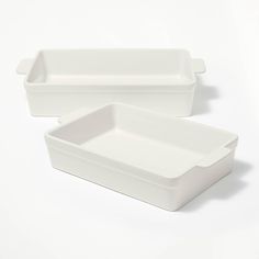 two white rectangular dishes sitting side by side on a white surface, one is empty and the other has no lid