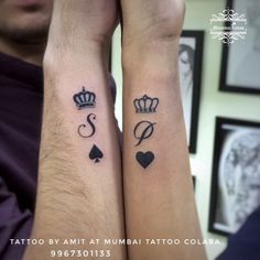 two people with matching tattoos on their arms, both have crowns and hearts tattooed on them