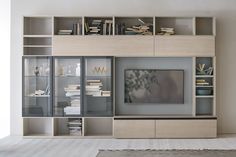 The Atlante AT221 wall unit by Tomasella is an ideal way to showcase your TV and pieces of decor, as well as store and organize belongings. With a larger-than-life structure, it features an array of base units and wall-mounted units that form a rectangular silhouette. There's a combination of shelves, flap-door compartments, glass-door cabinets, and drawers that are all spacious and hold your items with ease. Thanks to the contrasting finishes, it makes this product a gorgeous focal point i Tv Unit Bedroom, Bookshelves In Bedroom, Wall Storage Unit, Living Room Wall Units, Ikea Living Room, Living Room Arrangements, Tv Wall Unit, Glass Cabinet Doors, Living Room Collections