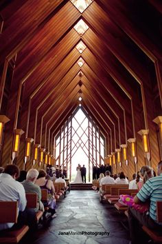 the inside of a church with people sitting in pews and looking at each other