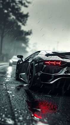 a black and white sports car driving on a wet road in the rain with red lights