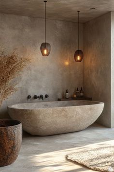 a large bath tub sitting next to a tall vase filled with dry grass on top of a floor