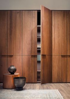 a room with wooden cabinets and a rug on the floor