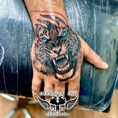 a hand with a tiger tattoo on it