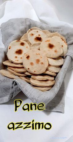 some pita breads are in a basket with the words pane azzzino