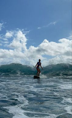 a person riding a surfboard on top of a wave in the middle of the ocean