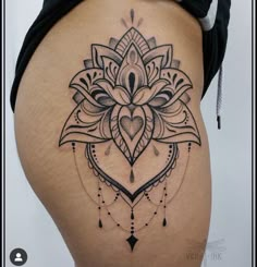 a woman's thigh with a tattoo design on it