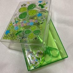 two clear boxes with green decorations on them