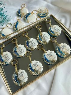 a tray that has some cupcakes on it with blue and white frosting