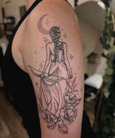 a woman's arm with a tattoo on it, and flowers around the arm