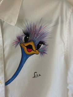 an emu painted on a white shirt with purple hair