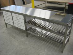 a metal workbench with drawers in a shop setting, ready to be worked on