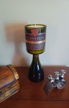 a lit candle sitting on top of a wooden table