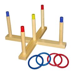 three wooden pegs and four colored rings