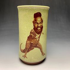 a ceramic cup with an image of a bearded man on it