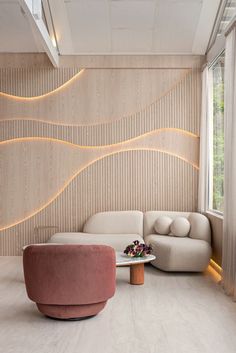 a living room filled with furniture next to a window and a wall covered in wooden slats