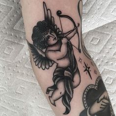 an angel tattoo on the leg of a woman