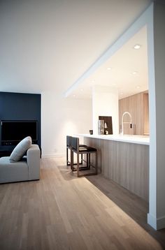 a living room filled with furniture and a flat screen tv on top of a wall