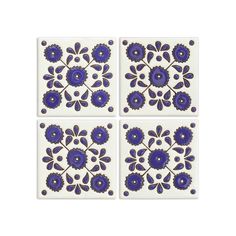 three blue and white tiles with flowers on them