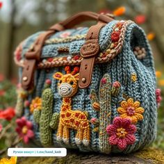 a crocheted purse with giraffes and flowers on it