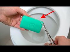 someone is using scissors to cut the lid on a toilet