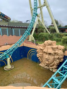 a roller coaster in the middle of a muddy area