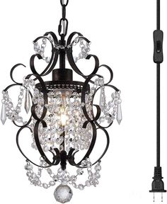 a black chandelier with crystal drops hanging from it