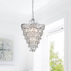 a chandelier hanging from the ceiling in a white room