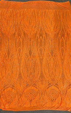 an orange piece of cloth with beading on it