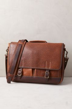 The Messenger Briefcase offers the ultimate leather bag that speaks volumes about your discriminating taste. Our classic briefcase design is handcrafted of shrunken bison leather boasting a premium rustic texture like no other leather. And it's contrasted by solid antiqued brass hardware and Horween Latigo leather straps that fasten the front flap over two roomy pockets, where you can slide your cell phone and keys. The tartan plaid-lined interior, featuring a snap pocket, and two open pockets f 39 Steps, Concealed Carry Bags, Camping Vacation, Bison Leather, Rustic Texture, Sheepskin Coat, Tartan Fabric, Antique Brass Hardware, The Messenger