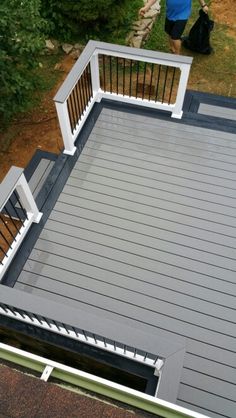 a person standing on top of a wooden deck