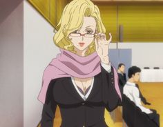 a woman with glasses and a pink scarf is talking on her cell phone while another man sits in the background