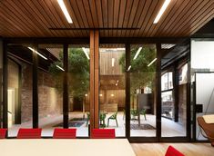 an indoor dining area with red chairs and tables