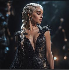 a woman with long hair wearing a black dress and braids on her head, standing in front of lights