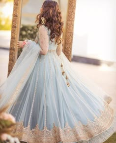 a woman in a blue and gold wedding dress