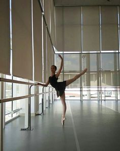 a young ballerina is practicing her ballet moves