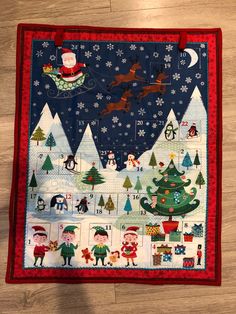 a quilted christmas scene with santa and his sleigh