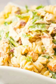 pasta salad with chicken and lettuce in a white bowl