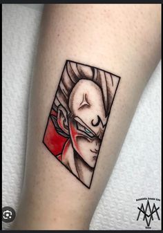 a tattoo on the leg of a person with a red heart in his eye and an image of a woman's face