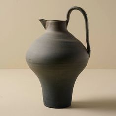 a gray vase sitting on top of a table